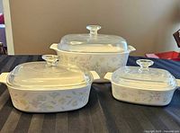 Front view showing three CorningWare Pastel Bouquet casseroles with lids