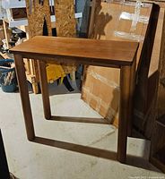 front view of solid wood console table showing overall design and legs