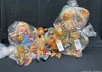 Group shot of all six Annalee scarecrow dolls in sealed plastic bags