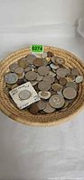 Top view of basket filled with assorted coins
