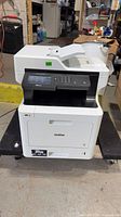 Front view of Brother MFC-L8900CDW printer on dolly