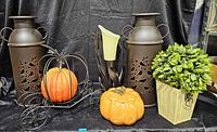 Full lot view: two metal lanterns, pumpkin stand with faux pumpkin, ceramic pumpkin dish, candle holder, planter with faux plant