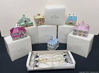 Group shot of six Lenox village buildings with boxes and lighting harness