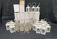 Group shot showing boxed and unboxed lanterns, beaded holders, scroll stands