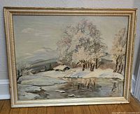 Front view of framed winter landscape painting
