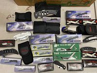 Entire grouping of boxed and loose knives with sheaths visible