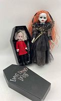 Both dolls with coffin boxes visible