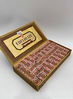 Open Edelblatt cigar box showing rows of stamp bundles