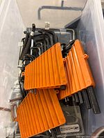Bin containing multiple hex keys, orange organizers, small bit case