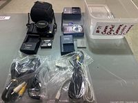 Complete lot showing both cameras, chargers, case and cables