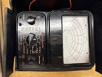 Front view of Simpson Model 160 multimeter showing dial, meter face, Simpson branding