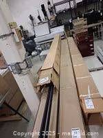 Long boxed extrusions stacked on table