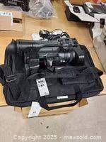 Camcorder seated in soft carry bag with accessories tag visible