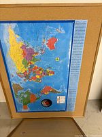 Front view of three cork boards showing frames and cork surfaces; center board displays map for scale