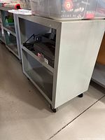 Angled side view showing shelves, wheels, power cord