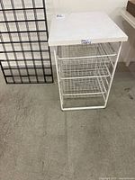 Full view of wire drawer organizer showing frame, three baskets and top surface