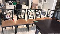 Six matching wood dining chairs aligned