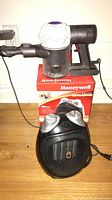 Dyson vacuum on Honeywell box beside Honeywell space heater