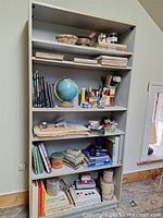 Full view of bookshelf with all items visible on five shelves