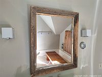 Frontal view of mirror showing dimensions and wall mounting