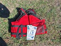 Front view of red Buoy O Boy lifejacket with tags attached