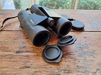 Binoculars front view with objective lens caps open