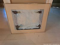 Full view of framed artwork showing abstract painting, mat, and frame