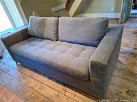 Full view of grey hide-a-bed sofa showing upholstery and size