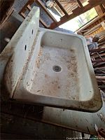Angled top view of entire sink showing basin, drain and apron