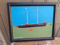 Full view of framed oil on board painting showing schooner scene