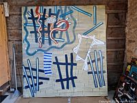 Full view of David Urban abstract painting leaning against wooden wall