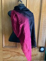 Full view of silk scarf draped to show red and black sides