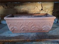 Front view of rectangular terra cotta planter with foliate relief
