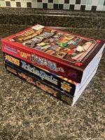 Stack of three Uncle John’s Bathroom Reader paperbacks showing spines