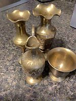 Group shot of four brass pieces