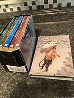 Slipcase with five paperbacks and one hardcover displayed