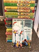Front view of stack showing assorted spine colours and front cover of Ice Carnival Mystery