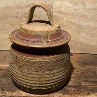 Full view of stoneware pot with lid and handle