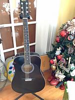 Full guitar on stand showing front, body, neck, headstock