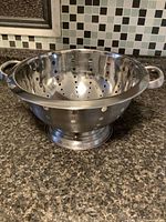 Top view of stainless steel colander showing perforations and interior