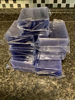 Stack of seven shrink-wrapped packs of plastic top loaders