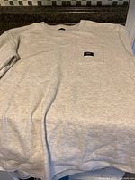 Full view of light grey Vans waffle knit sweatshirt laid flat