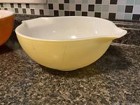 Side view of yellow Pyrex bowl showing color and wear