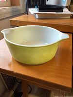 Side view of green Pyrex bowl on table