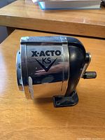 Front view showing X-Acto KS logo, crank handle and mounting base