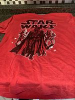 Full view of red Star Wars T-shirt laid flat
