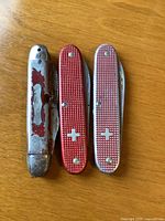 All three pocket knives closed showing handles