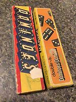 Both domino set boxes closed, showing graphics