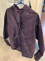 Front view of purple pinstripe Columbia winter jacket on hanger