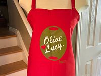 Front view of red Olive Lucy apron on mannequin